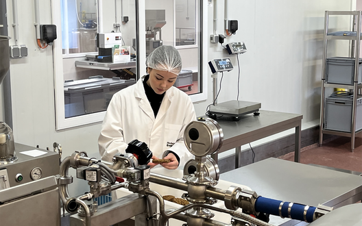 Eine Frau steht an einer Produktionslinie für Lebensmittel.  | © BIS Bremerhaven/ aheads GmbH